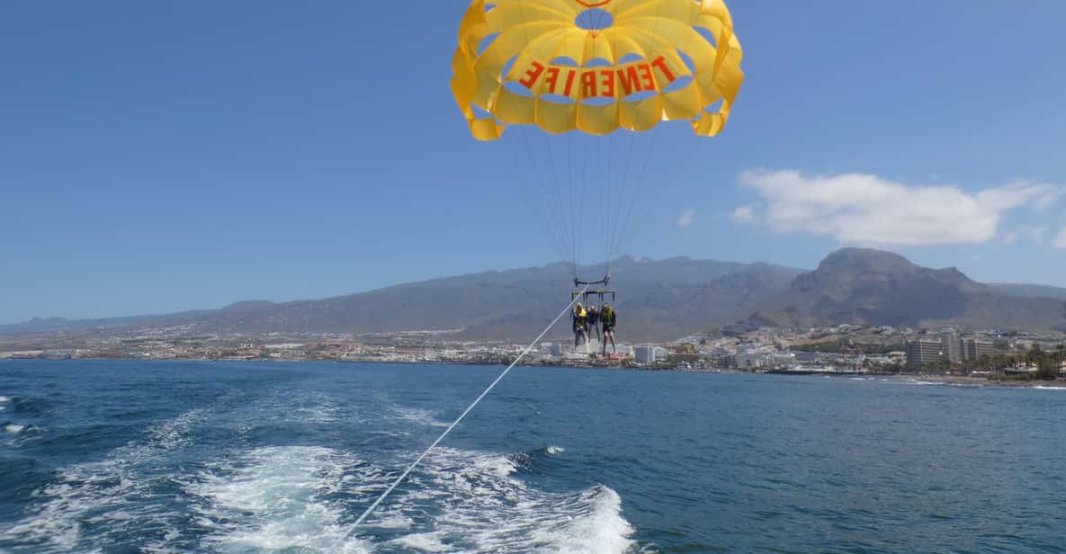 Parasailing above the turquoise waters of Playa de las Américas in Tenerife